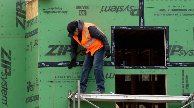 Fewer Americans file for jobless benefits last week, but applications remain slightly elevated